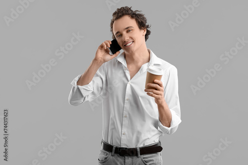 Young man with cup of coffe...