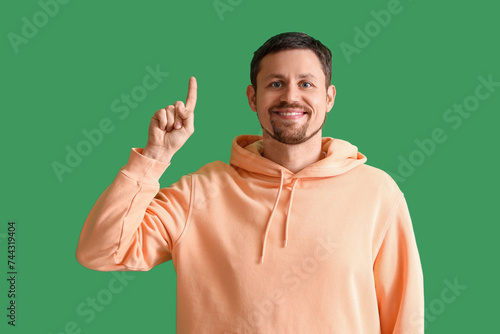 Handsome man pointing at so...