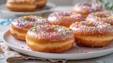 Festive carnival-themed donuts with colorful sprinkles on a white platter, vibrant daylight scene
