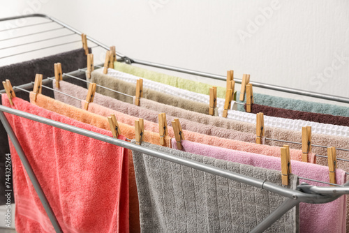 Clean towels hanging on dryer, closeup