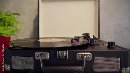 Closeup of vintage record player spinning vinyl indoors photo