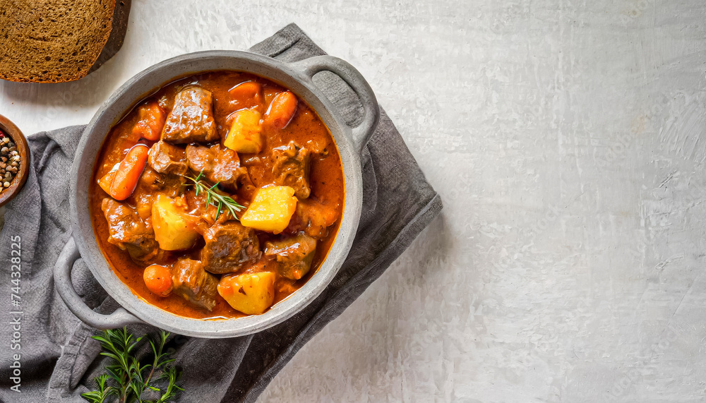 Beef stew. top view shot of Beef stewed in tomato sauce on black pan, copy space, beef dish Beef stew. top view shot of Beef stewed in tomato sauce on black pan, copy space, beef dish