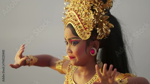 authentic balinese dancer dancing with dramatic facial expression, bali tourism photo