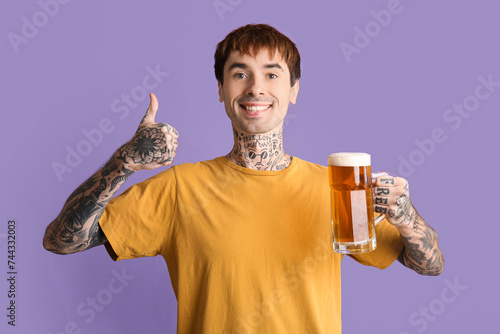 Tattooed young happy man wi...