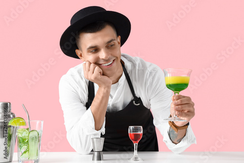 Young male bartender with c...