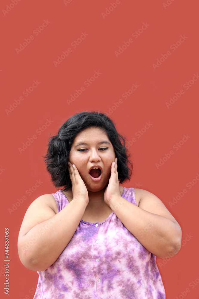Young 20 year old Latin brunette woman suffers from pain in her teeth due to cavities or infection in her molars Young 20 year old Latin brunette woman suffers from pain in her teeth due to cavities or infection in her molars