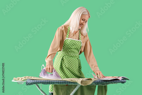 Happy mature woman in apron...