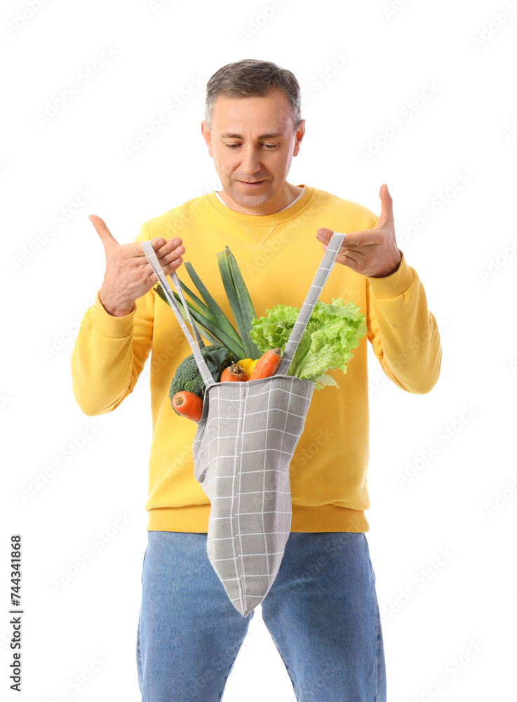 Mature man with shopping bag of fresh vegetables on white background Mature man with shopping bag of fresh vegetables on white background
