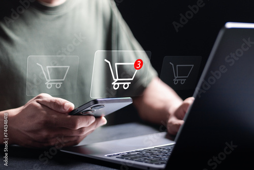 business ecommerce concept, online purchase, ecommerce store, online business, shopping on the internet. Person use smartphone and laptop with online shopping cart icon on virtual screen.