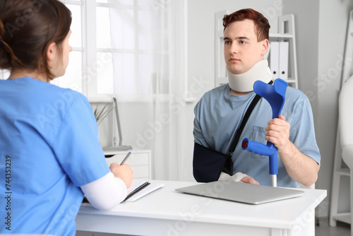 Young man with neck brace a...
