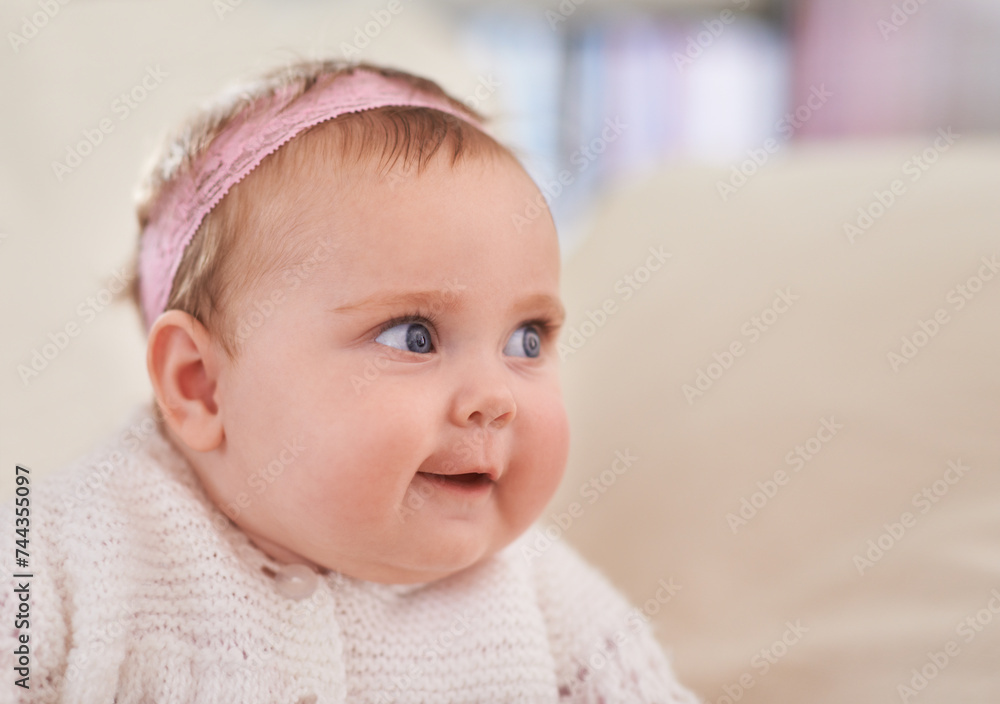 Happy, baby girl and face in a home with a calm, relax and sweet infant in a living room. Youth, child and house with toddler clothing in the morning ready for a nap on the sofa with joy and headband Happy, baby girl and face in a home with a calm, relax and sweet infant in a living room. Youth, child and house with toddler clothing in the morning ready for a nap on the sofa with joy and headband