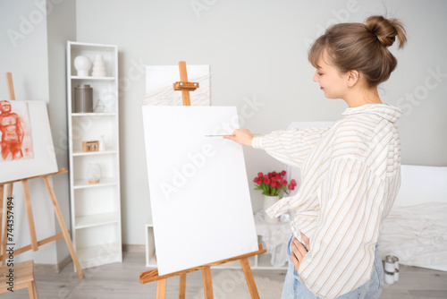 Female artist painting on c...