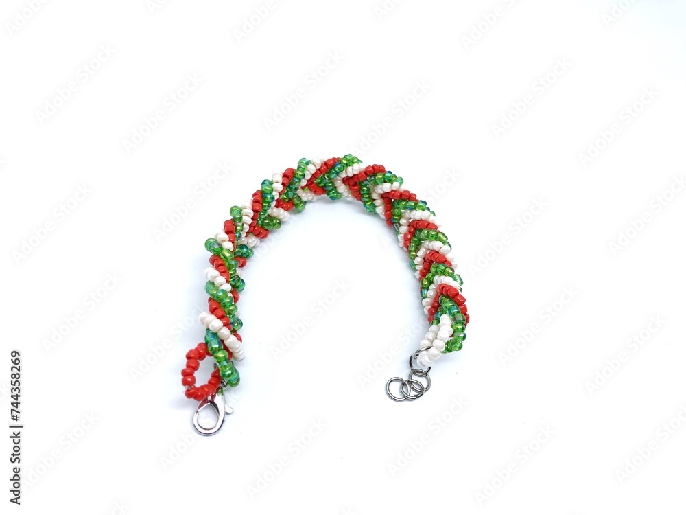 Fototapeta premium Beaded bracelet with Christmas motif on white background
