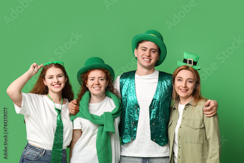 Group of people hugging on green background. St. Patrick's Day celebration