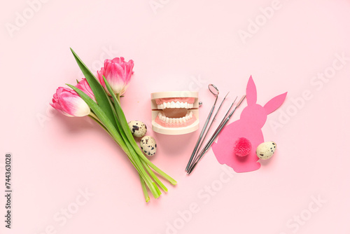 Composition with dentist's tools, tulip flowers and Easter decor on pink background #744363028