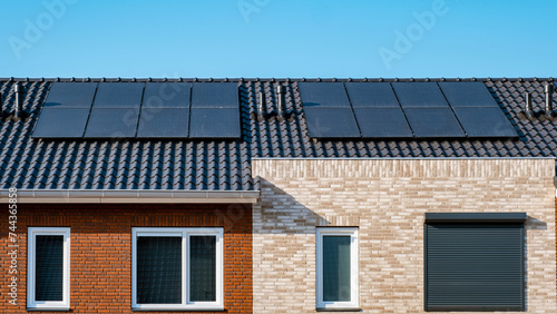 Close up of new building with black solar panels. Zonnepanelen, Zonne energie, Translation: Solar panel, Sun Energy