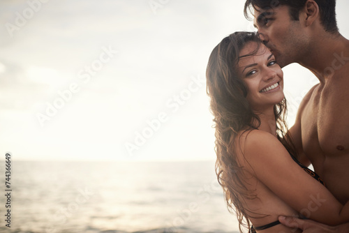 Portrait, happy couple and kiss at sea at sunset on vacation, holiday or travel together. Face, man and woman at ocean for adventure, romance or connection in summer by water for love on mockup space