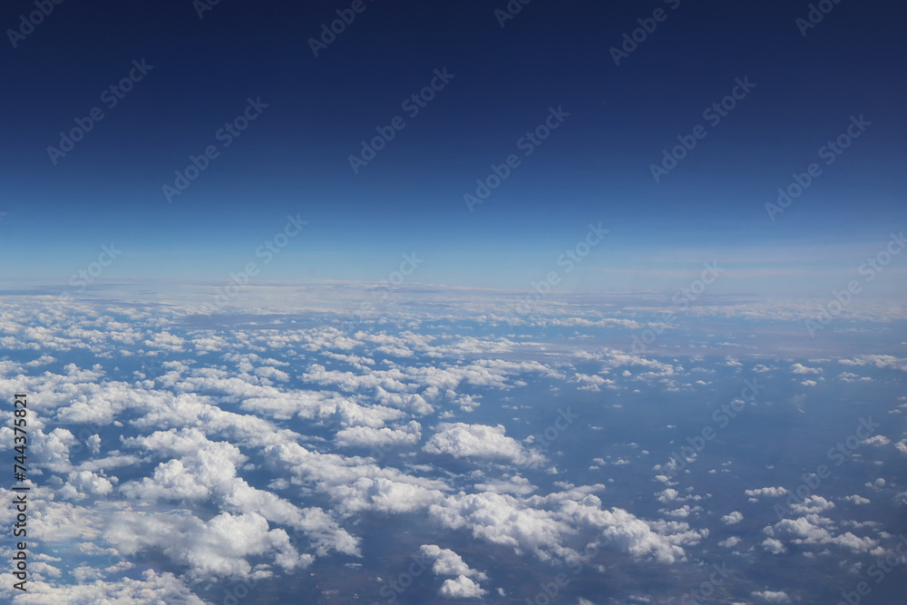 Dramatic horizon freshness deep blue sky aerial view from aircraft with soft white clouds on summer tropical climate. Image use for environment and meteorology forecast presentation background.