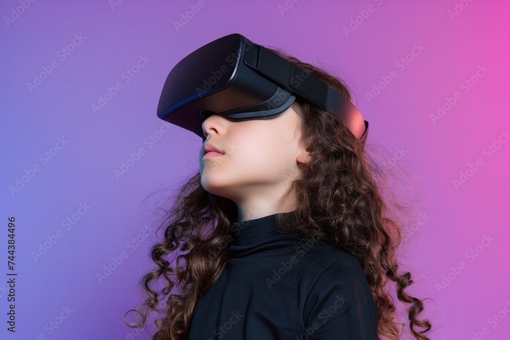 Hispanic or Mediterranean Young Kid Girl Wearing VR Headset, Enjoying Virtual Reality Experience on Gradient Background with Neon Studio Lighting. Horizontal Photo Banner (3:2) Hispanic or Mediterranean Young Kid Girl Wearing VR Headset, Enjoying Virtual Reality Experience on Gradient Background with Neon Studio Lighting. Horizontal Photo Banner (3:2)