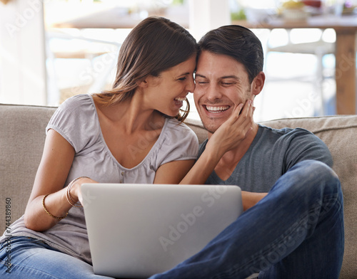 Happy couple, laptop and love on sofa with good news, support or care in living room at home. Excited man or woman with smile on computer together for online browsing, alert or notification at house