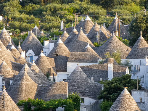 Alberobello Italy - traditional trulli houses with conical stone roofs. Famous landmark, travel destination and tourist attraction near Bari in Puglia, Europe. Old Mediterranean architecture.