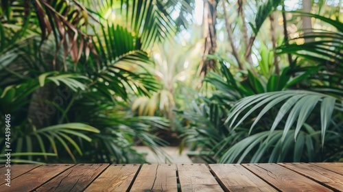 Wood tabletop podium floor in outdoors tropical garden forest blurred green palm leaf plant nature background.Natural product placement pedestal stand display jungle paradise concept.