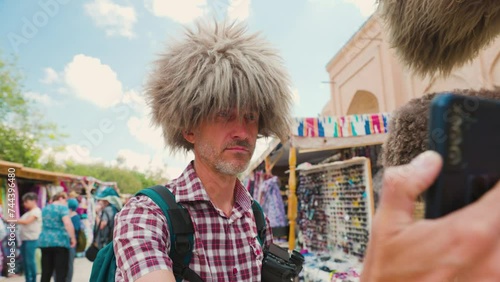 Man tourist at street market in Khiva photo