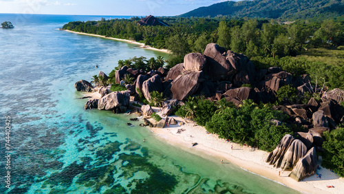 Drone top view at Anse Source d'Argent beach La Digue Island Seychelles, Drone aerial view of La Digue Seychelles, tropical vacation summer holiday, a beach with huge granite rocks at sunset