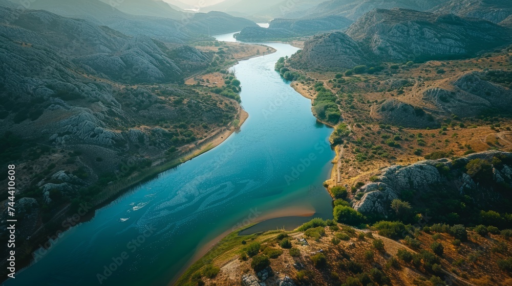 A meandering river carving its way through rocky terrain