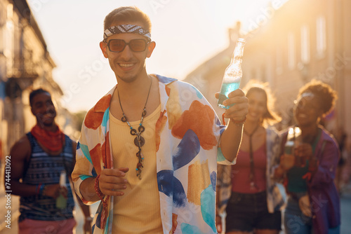 Happy man going with friends on summer music festival and looking at camera. photo