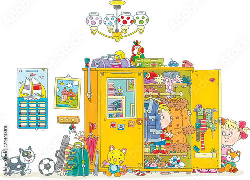Funny little boy and girl playing hide and seek with their cat in a large closet full of different clothes, shoes, many other things and toys in a home hallway, vector cartoon illustration on white