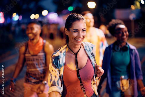 Happy festival goer and her friends having fun on music concert at night. © Drazen