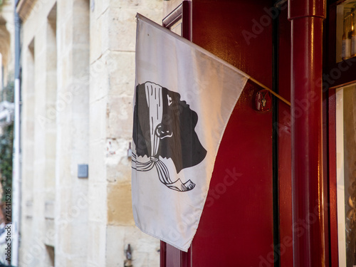 Corsican flag with its Moor head hanging on the facade home photo