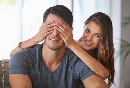 Portrait, smile and couple with surprise in home, love and happy people bonding together for romance. Face, man and woman covering eyes for connection, care and healthy relationship in living room © peopleimages.com