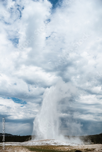 Old Faithful geyser erupting during summer in Yellowstone Nation