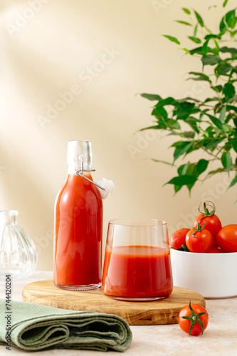 tomato juice in a bottle and glass on the table