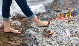 Legs of a girl walking on burning coals