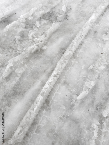 Traces from car wheels in the snow in winter as a background
