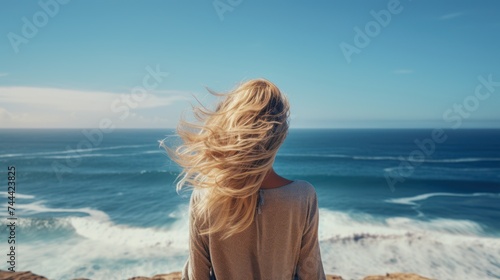 The back of a woman looking at  ocean Capture clean, women and loneliness © CStock