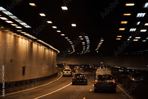 Cars travelling through city toll road underground tunnel in Sydney