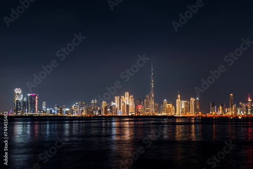 view of Dubai Downtown cityline from Dubai Creek Canal at night