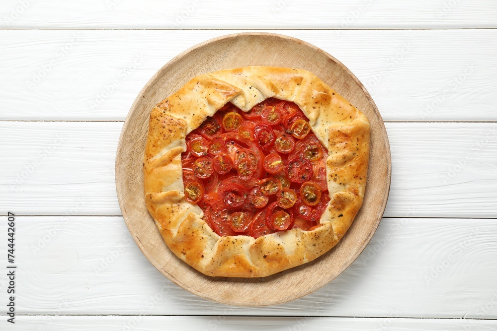 Tasty tomato galette (Caprese galette) on white wooden table, top view Tasty tomato galette (Caprese galette) on white wooden table, top view