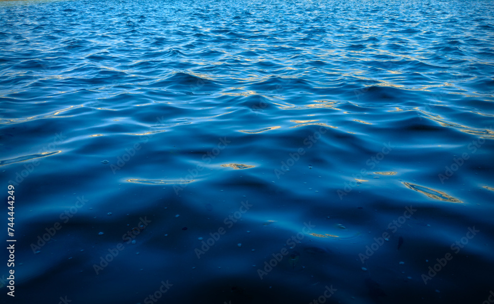 The rippling surface of a deep body of water The rippling surface of a deep body of water