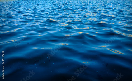 The rippling surface of a deep body of water