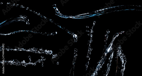 Various water jets isolated on a black background.