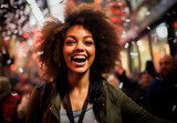 Cheerful young African American woman smiling with joy amidst a lively street party at night.