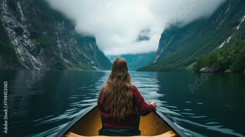 View from the back of a girl in a canoe, gliding through fjords. Ai Generated. © Nattakun