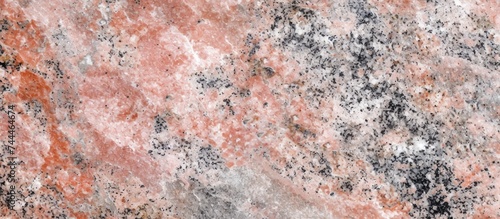 A detailed view of a pink granite counter top, showcasing the intricate pattern of natural material formed by rock, soil, water, and science.