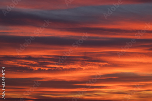 Dramatic sunset with vibrant clouds lit by a sun
