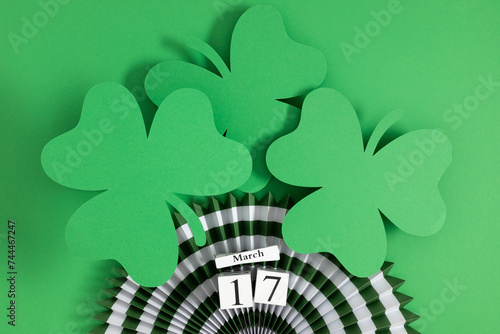 Block calendar for St Patrick's Day, March 17 ,with green clover leaf and decorations on green background. Celebrating St. Patrick's Day.